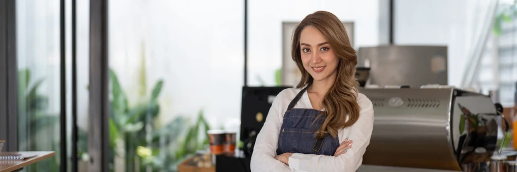 restaurant employee - female - smiling because she is about to get paid through ideal payroll processes
